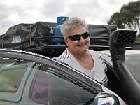 Chris is smiling after the roof top tent is securely back in place