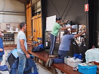 Many hands make light work as the guys reposition the pics